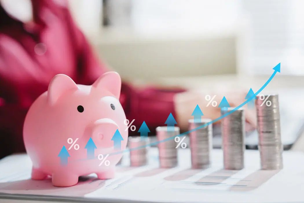 piggy bank with stacks of coins illustrating compounding interest