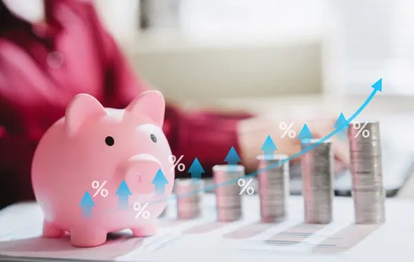 piggy bank with stacks of coins illustrating compounding interest